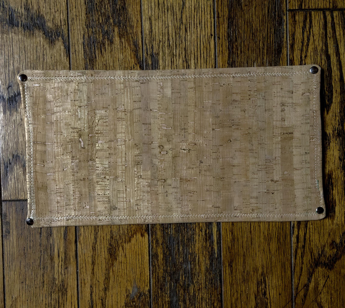 cork backing of the leather table protector pad shown from underneath.